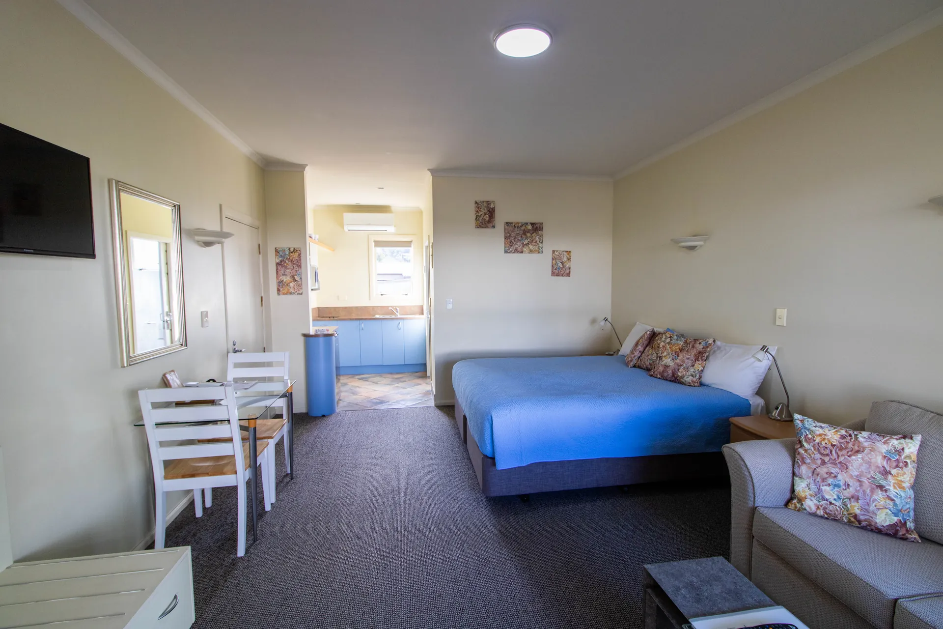 Access Studio Bed and Kitchenette Access Studio king bed and sofa with the kitchenette and dining area beyond