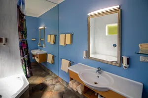 King Studio Bathroom Vanity King Studio bathroom with vanity, large framed mirror, corner bath and fresh towels