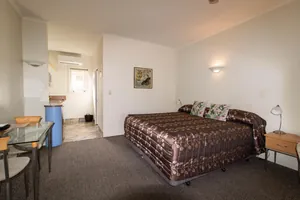 Studio King Bed and Kitchenette Studio king bed with dining table and kitchenette beyond at Tuscany on Thames