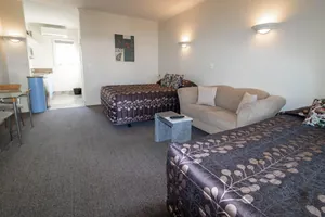 Studio Twin Beds and Sofa Twin Studio with two beds, sofa and glass dining table at Tuscany on Thames